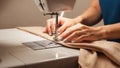 Seamstress Hands Guiding Fabric - Sewing Machine Close-Up - Craftsmanship Detail Royalty Free Stock Photo