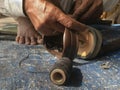 Skilled hands using needal & working on roadside shoe repairer in Kalyan