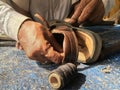 Skilled hands using needal & working on roadside shoe repairer in Kalyan