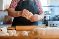 Skilled Latina Cook Creating Dough by Hand with Rolling Pin in Countryside Kitchen Scene