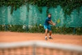Skilled male tennis player at outdoor court