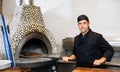 Skilled man chef preparing pizza in restaurant Royalty Free Stock Photo