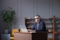 Skilled man programmer developing application software and using laptop computer and a notebook to record-keeping Royalty Free Stock Photo