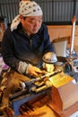 Skilled man using lathe tool to make a crafted pen in Tsumago, J