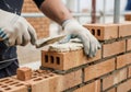 Skilled mason constructing a brick wall with precision and care for durable building Royalty Free Stock Photo