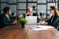 Skilled mature adult male businessman having meeting with diverse multi-ethnic business colleagues i Royalty Free Stock Photo