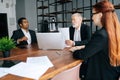 Skilled mature adult male businessman having meeting with diverse multi-ethnic business colleagues i Royalty Free Stock Photo