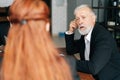 Skilled mature adult male businessman having meeting with diverse multi-ethnic business colleagues i Royalty Free Stock Photo