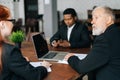 Skilled mature adult male businessman having meeting with diverse multi-ethnic business colleagues i Royalty Free Stock Photo