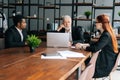 Skilled mature adult male businessman having meeting with diverse multi-ethnic business colleagues i Royalty Free Stock Photo