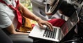 Skilled mechanic using a laptop computer to check a car engine