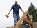 Skilled men building a barn at the annual Apple Cider Festival