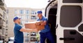 Skilled Movers in Action: Experienced Caucasian Men Loading Boxes into Delivery Royalty Free Stock Photo