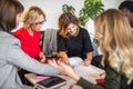 Skilled multicultural female bloggers discussing new themes for media web page.