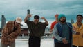 Skilled multicultural street dancing group pose at camera at roof top. Endeavor.