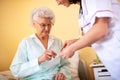 Skilled nursing facility doctor explaining to senior woman occupant which medications she should be taking