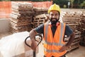 Happy Hispanic Manual Worker With Forklift Smiling At Camera