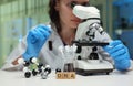 A skilled scientist is analyzing DNA samples with a microscope in a sophisticated lab Royalty Free Stock Photo