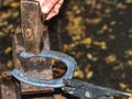 Skilled smith man striking a red hot horseshoe on the anvil Royalty Free Stock Photo