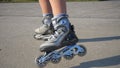 Skilled sport woman on the inline skates on park alley. Slow motion