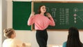 Skilled teacher asking for volunteer while mentor standing at class. Pedagogy. Royalty Free Stock Photo