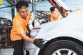 Skilled technician make refurbishment of bodywork in automotive service. Oxus