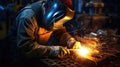 A skilled welder working on welding metal, creating sparks and
