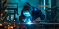 Skilled Welder works in a fabrication shop welding metal work - They are wearing protective Fire resistant clothing Royalty Free Stock Photo