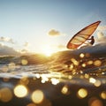 Sunset Windsurfing: A Jump Above Waves with Sparkling Reflections Royalty Free Stock Photo