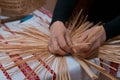 Skilled woman plaits a straw bag at ethnographic master class, traditional craft art, Vinnytsia, Ukraine, 19.03.2018