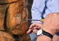 Skilled Wood Carver is working on recreating an old viking statue