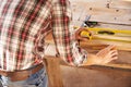 Skilled woodwork. A handyman getting his measurements just perfect with a spirit level and measuring tape.