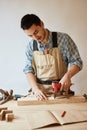 Carpenter drills a hole with an electrical drill Royalty Free Stock Photo