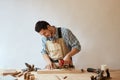 Carpenter drills a hole with an electrical drill Royalty Free Stock Photo