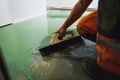 Skilled worker applies green epoxy paint