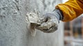 Skilled worker applying finishing plaster to a wall during renovation project in construction site Royalty Free Stock Photo