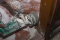 A skilled worker cleaning the bathroom floor with a machine