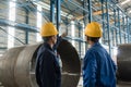 Skilled worker pointing up while giving instructions to an apprentice