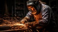 Skilled worker wearing protective gear while performing arc welding with an electric arc welder Royalty Free Stock Photo