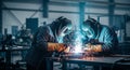 Skilled workers welding metal in an industrial plant sparks flying Royalty Free Stock Photo