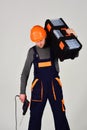 Skilled workman. Construction worker hold repair kit and drill. Working man or hard worker in work wear. Construction