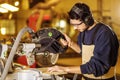 Skilled young carpenter cut a piece of wood Royalty Free Stock Photo