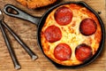 Skillet Pepperoni Pizza on Table Royalty Free Stock Photo