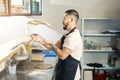 Skillful cook in apron making pizza dough fly Royalty Free Stock Photo