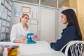 Skillful female doctor is consulting her patient. Young woman doctor is talking to her patient