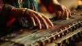 Skillful female hands playing traditional Indian instrument