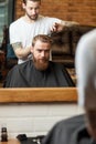 Skillful male hairdresser is serving his client Royalty Free Stock Photo