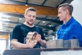 Master discussing a workpiece with his apprentice or trainee Royalty Free Stock Photo