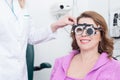 Skillful ophthalmologist with equipment for lens determination Royalty Free Stock Photo