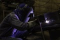 Skillful welders weld steel in the factory.